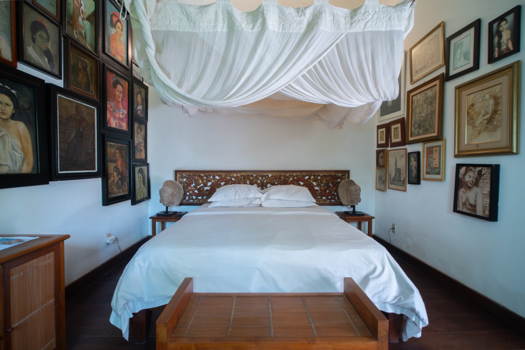 A four-poster bed under mosquito netting in the Bali accommodation