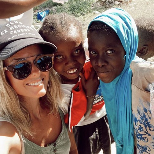 A traveller and local friends laughing together for a photo in Zanzibar